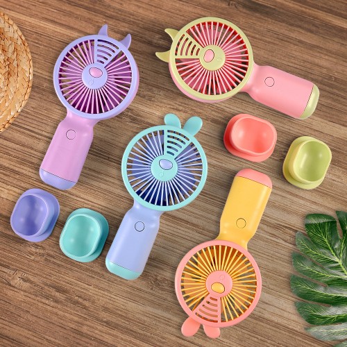 Ventilador portátil con soporte para teléfono celular y orejitas, variedad de diseños y colores.